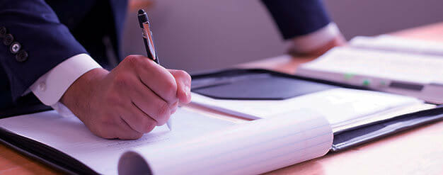a hand holding a pen